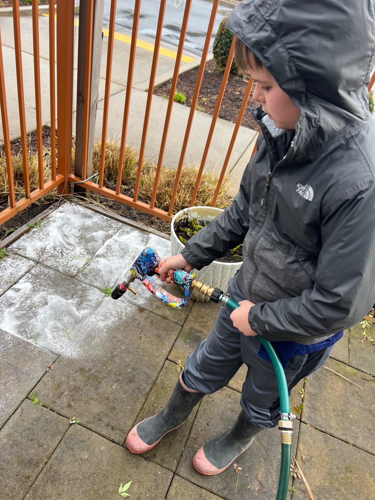 Young family member helping with an exterior cleaning project